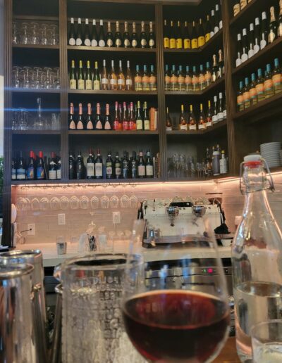 A glass of wine on a bar.